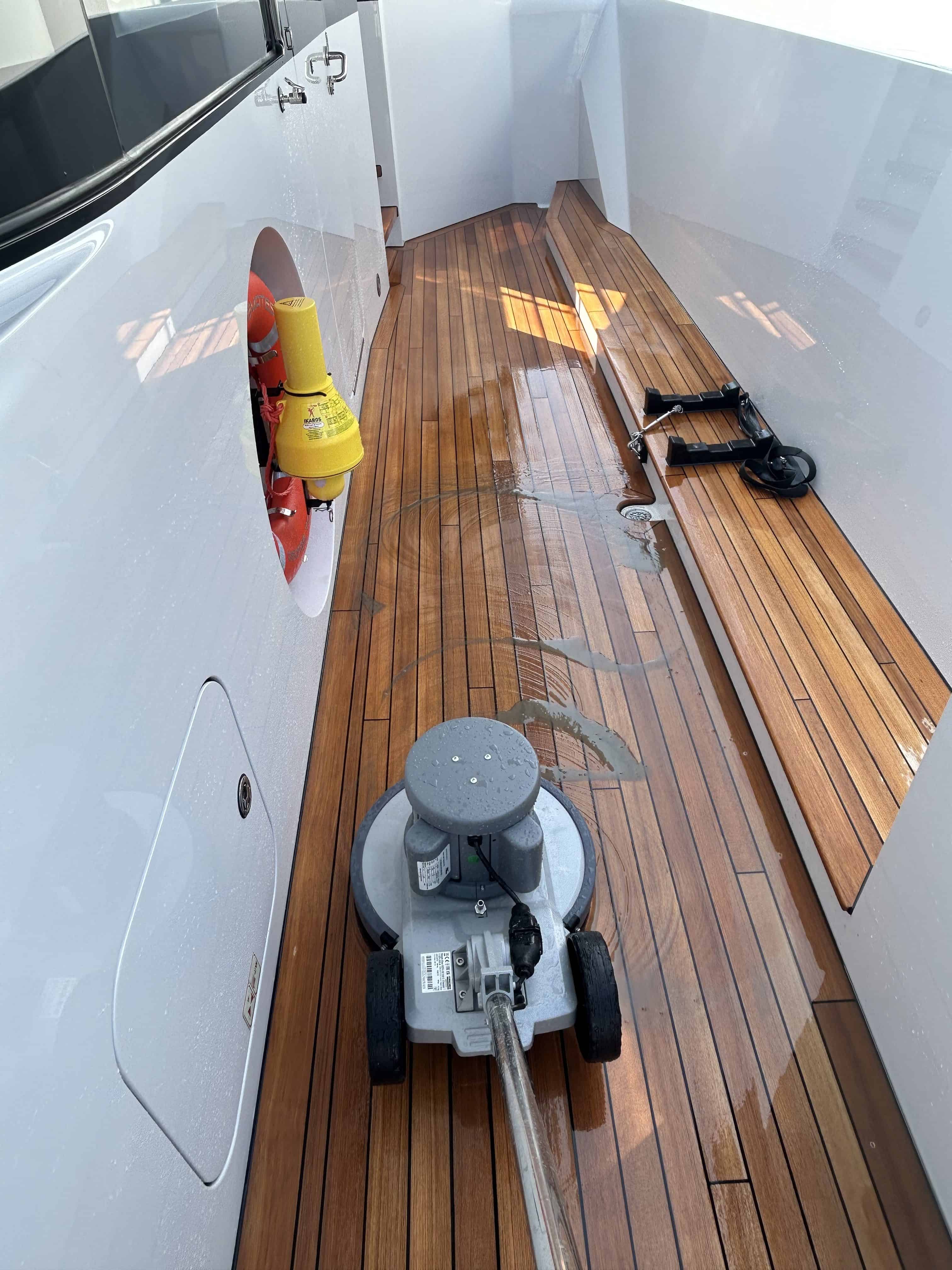 Teak being cleaned by a machine.