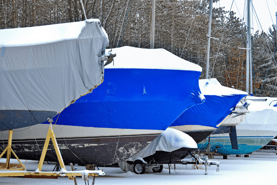 Boats with winter covers on and marine shrink wrap. Cold weather showing boat in winter storage. 
