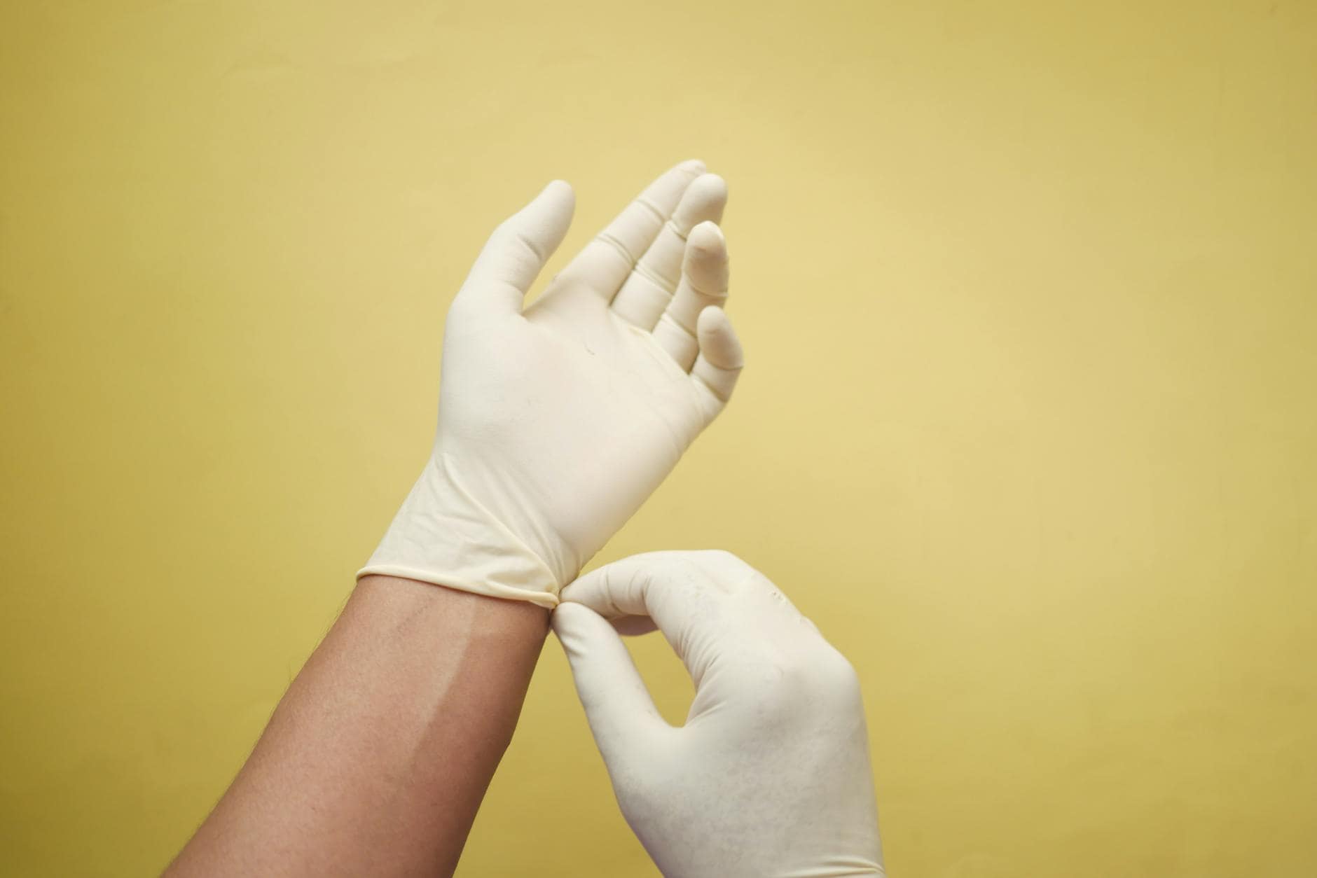 a person wearing latex gloves