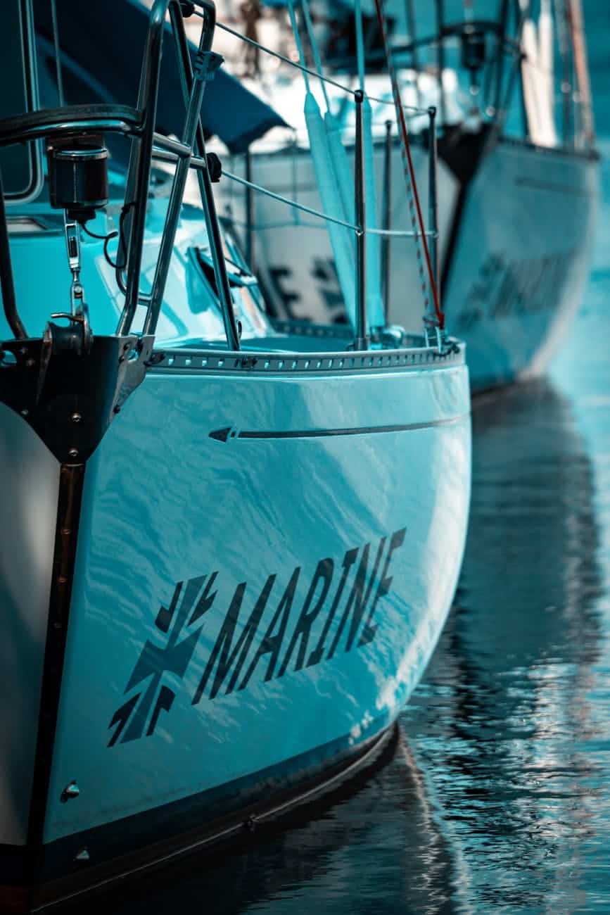 sailboat docked with reflections on water showing its gelcoat