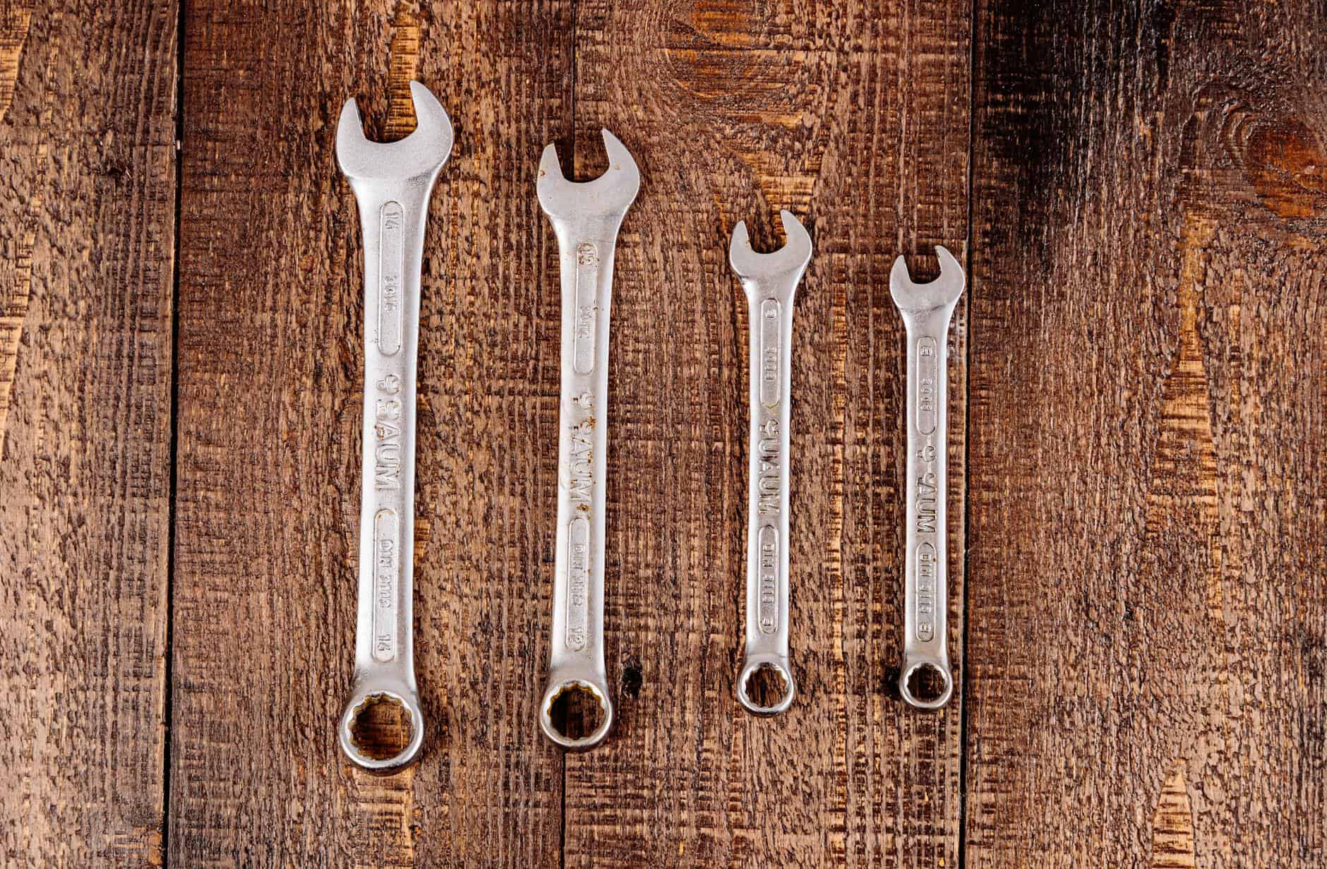 metal wrenches on a wooden surface for a tool kit for boats