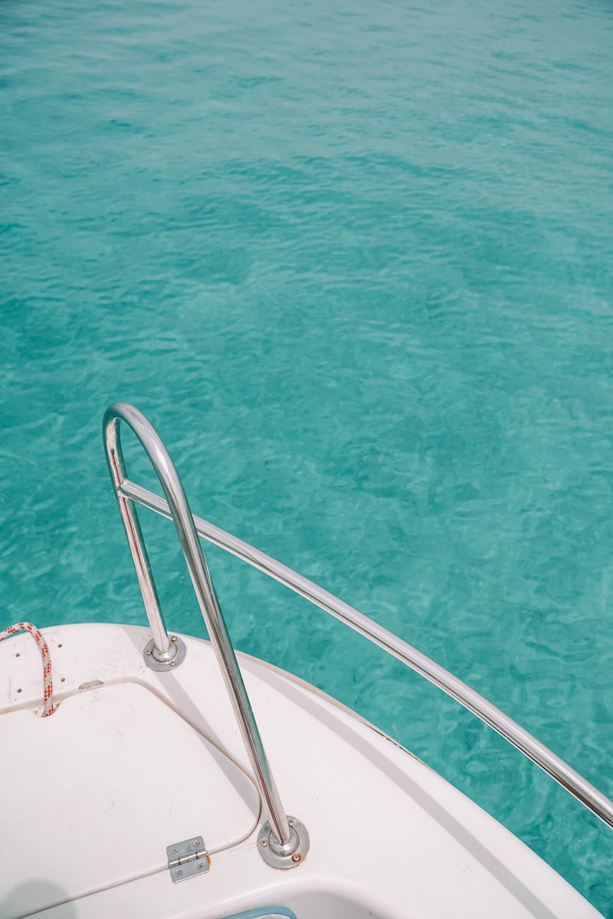 a white boat on body of water