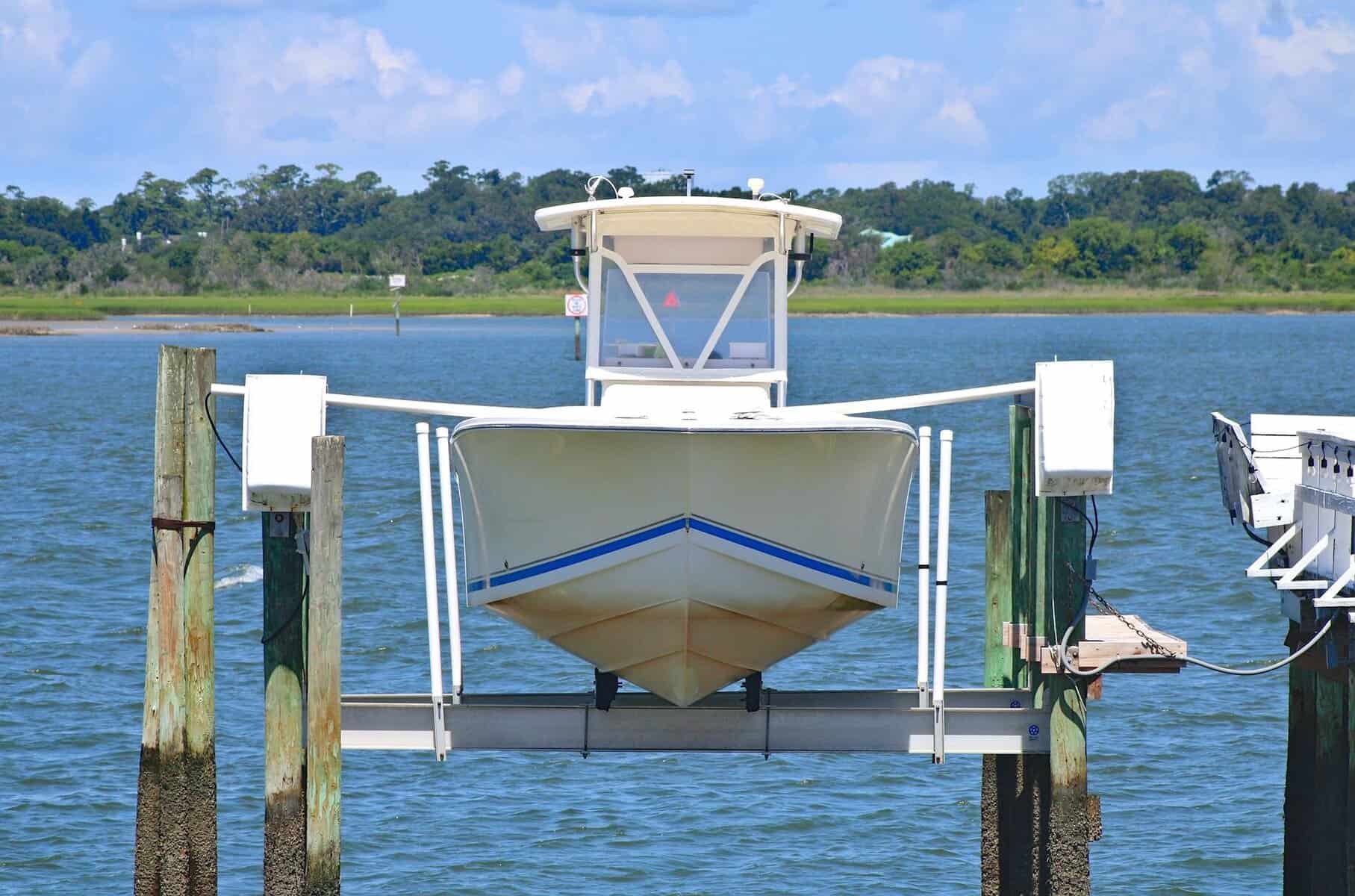 Small speed boat being lifted out of the water.