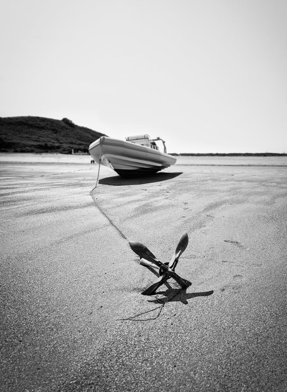 a boat with a anchor lying on the beach