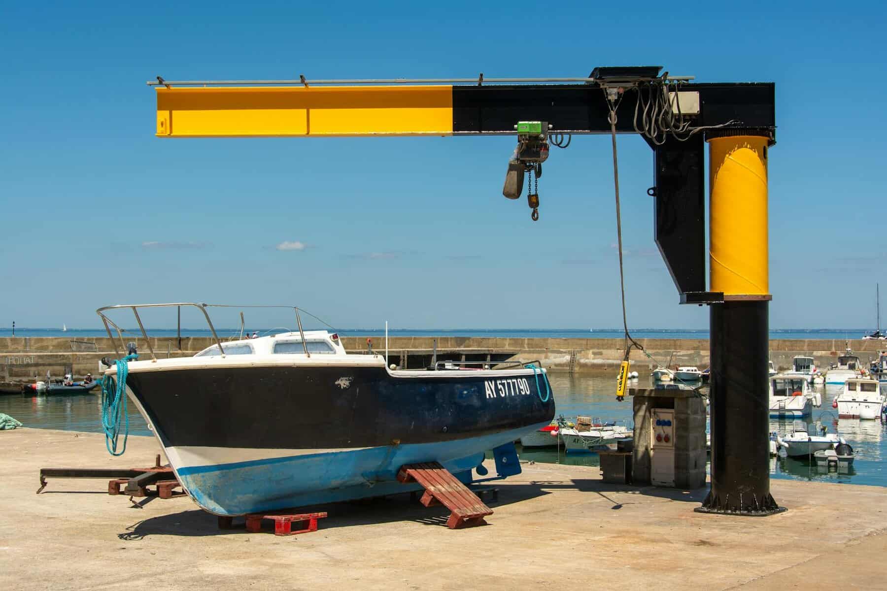 boat lift at marina with industrial crane