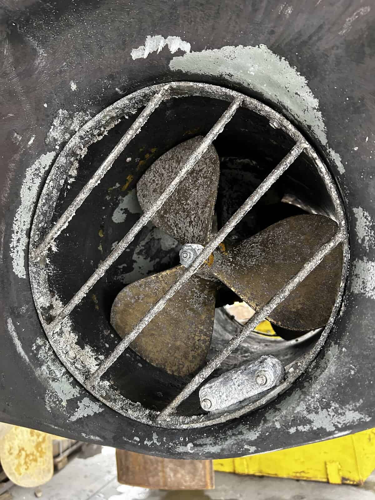 Yacht bow thruster paint being stripped ready for antifouling. 