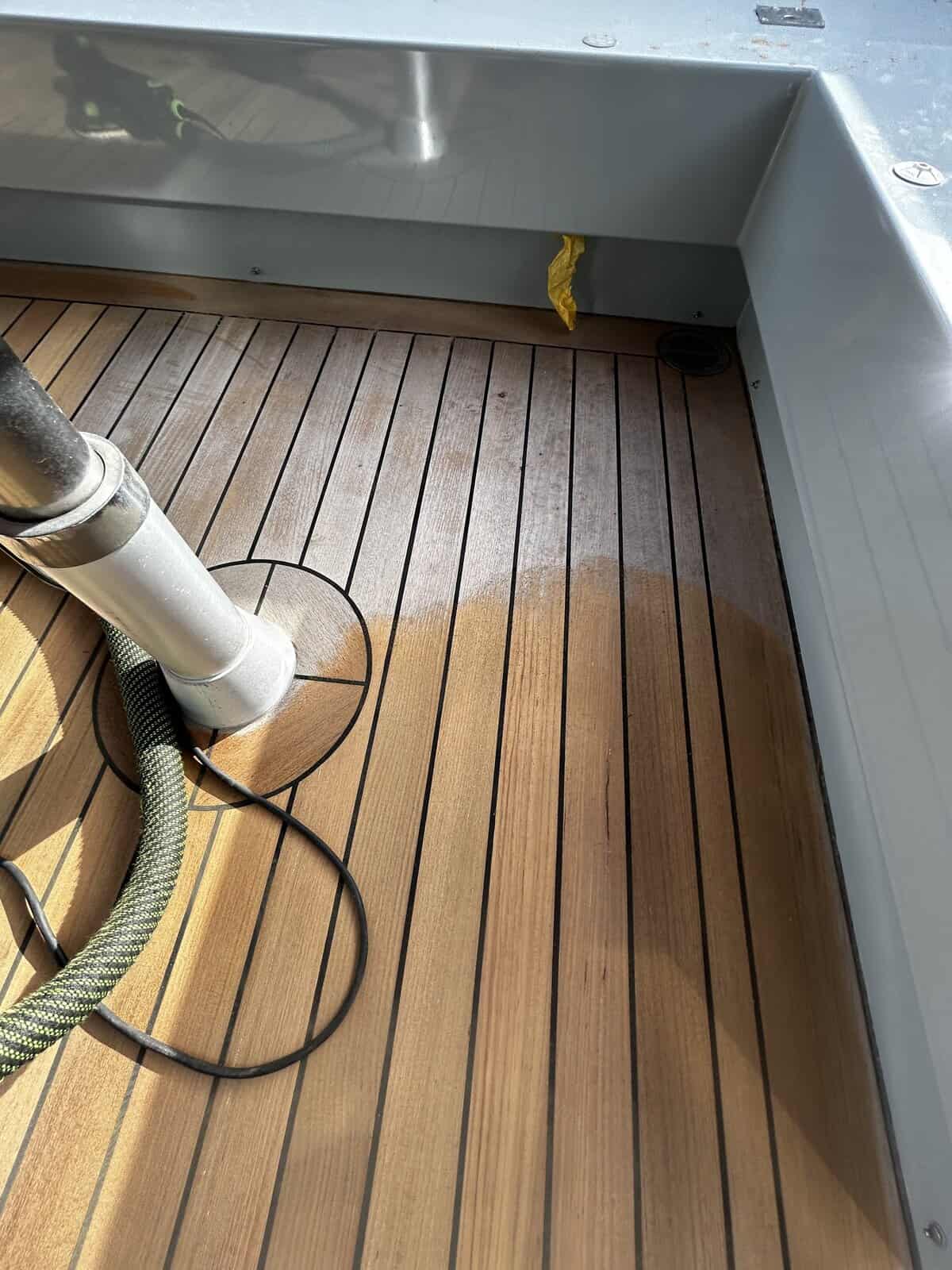 Old teak being sanded down. Showing old grey dirty teak in comparison to new freshly sanded teak deck . 