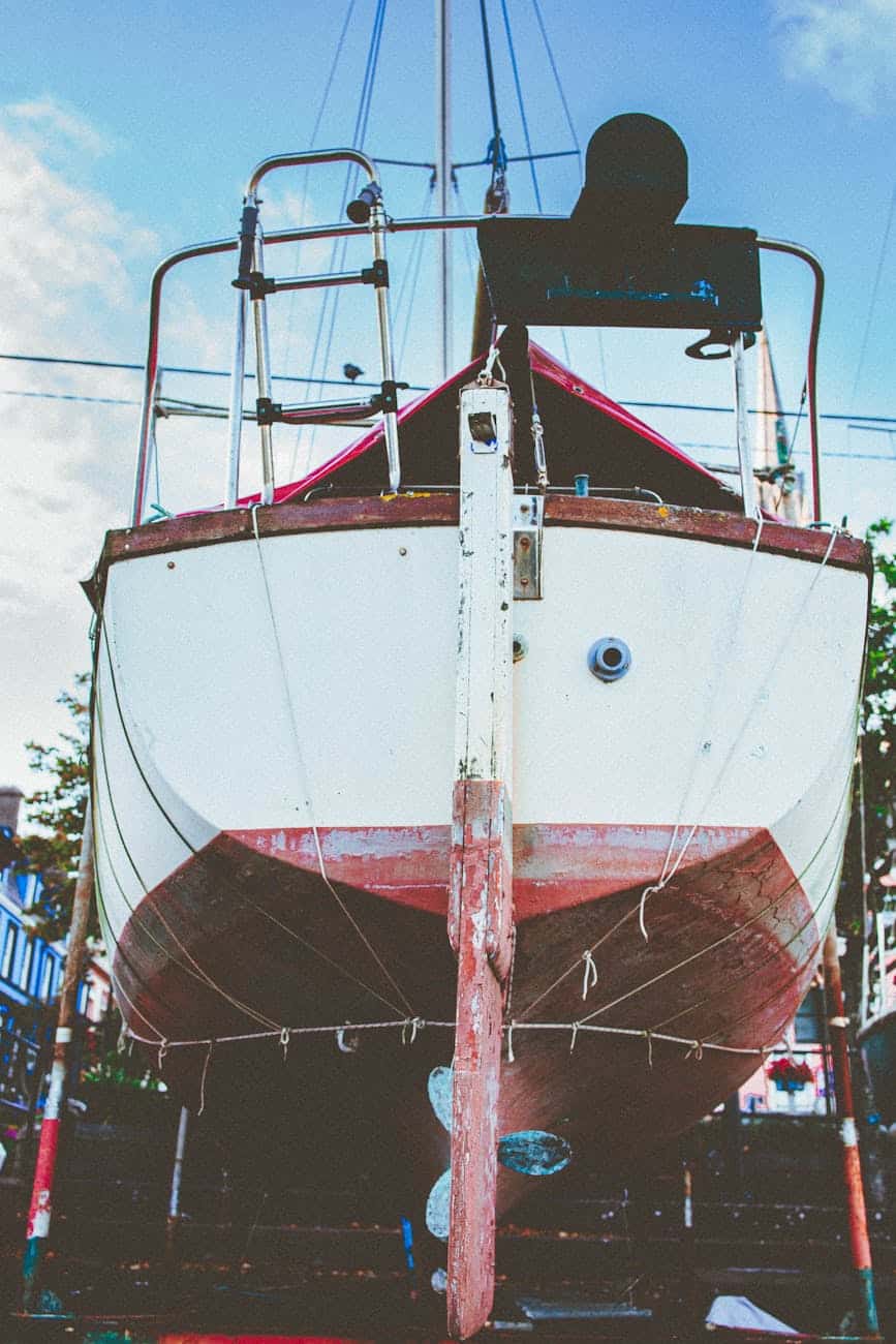 Boat maintenance of a sailing boat out of the water. 