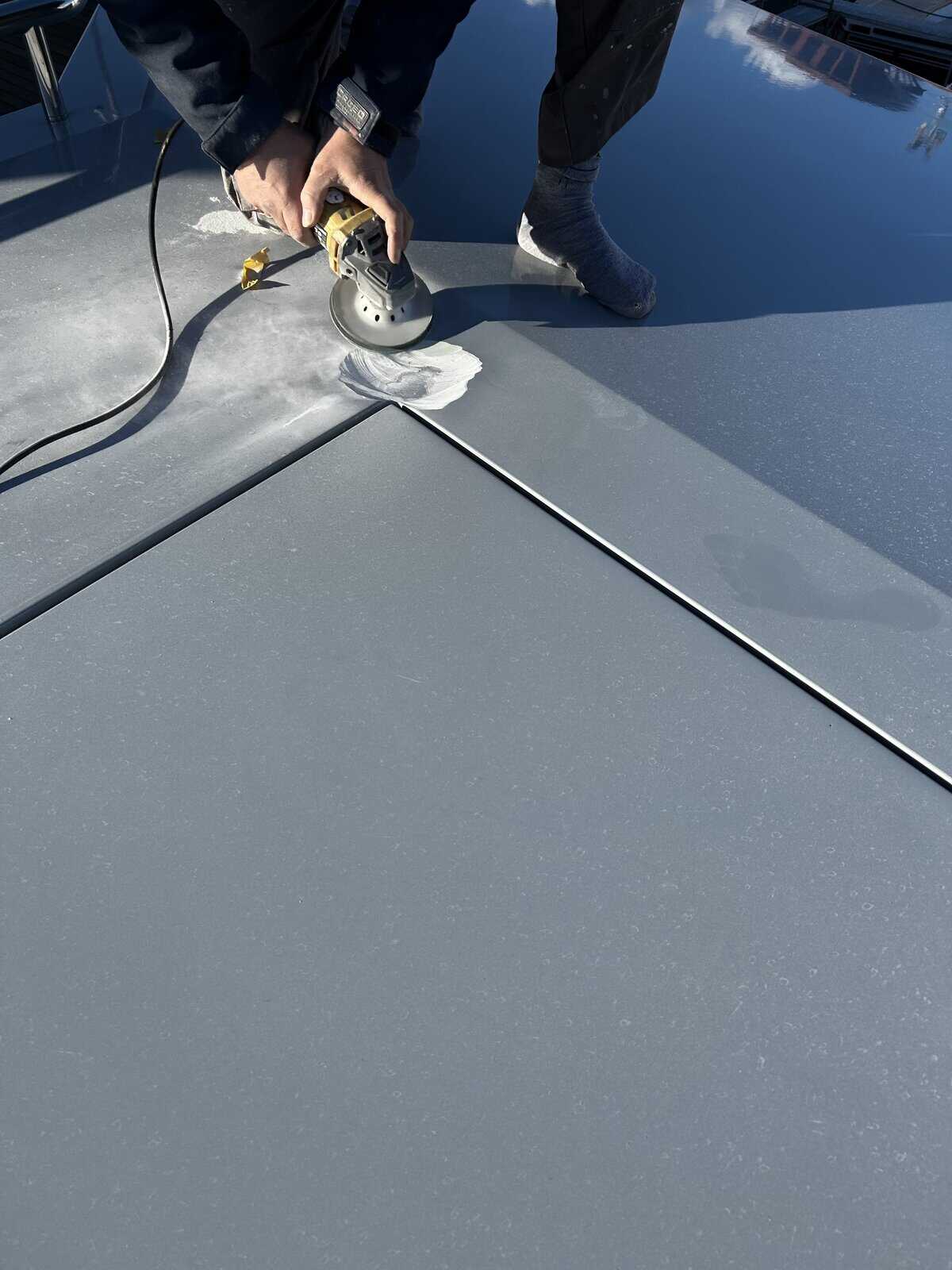 Yacht paint preperation started with grinder on grey marine paint. 