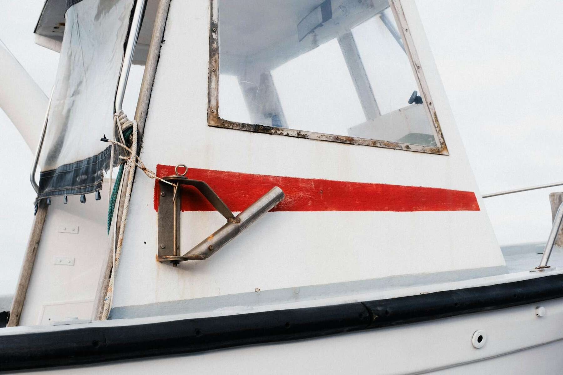 old white yacht paint with red paint sun damage. 