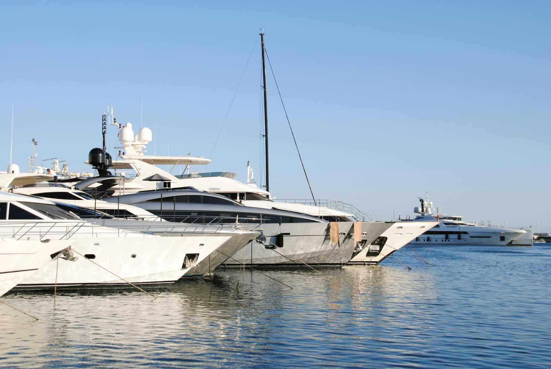 luxury yachts docked in cannes marina with gleeming yacht paint. 