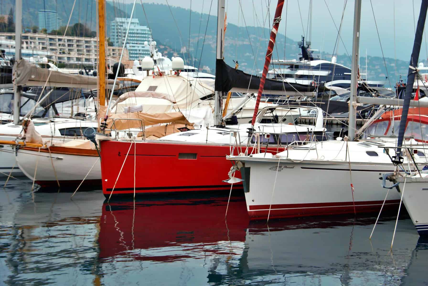 colorful yachts docked in monaco harbor showing brightly coloured hulls in the water