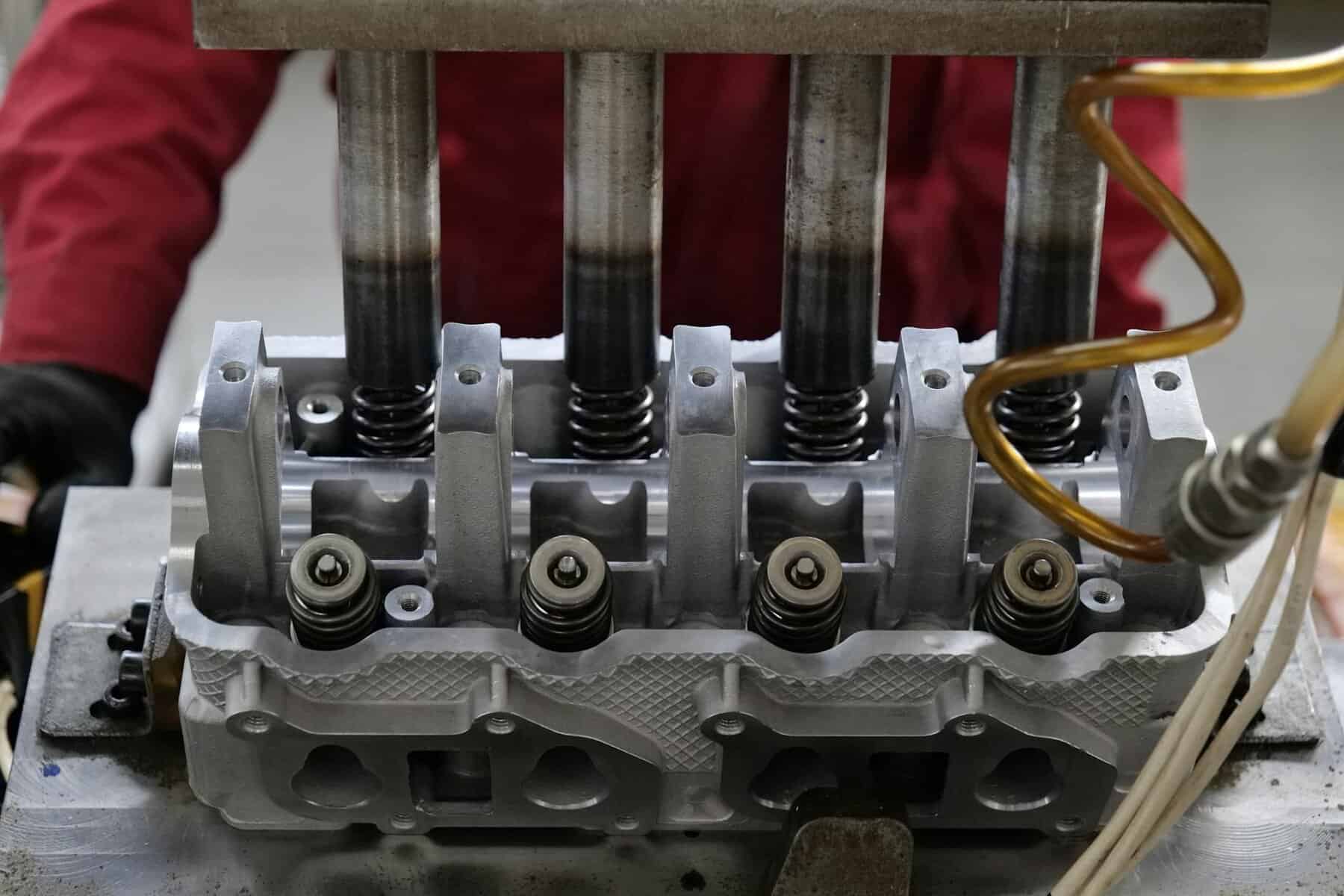 Outboard engine pistons undergoing maintenance. 