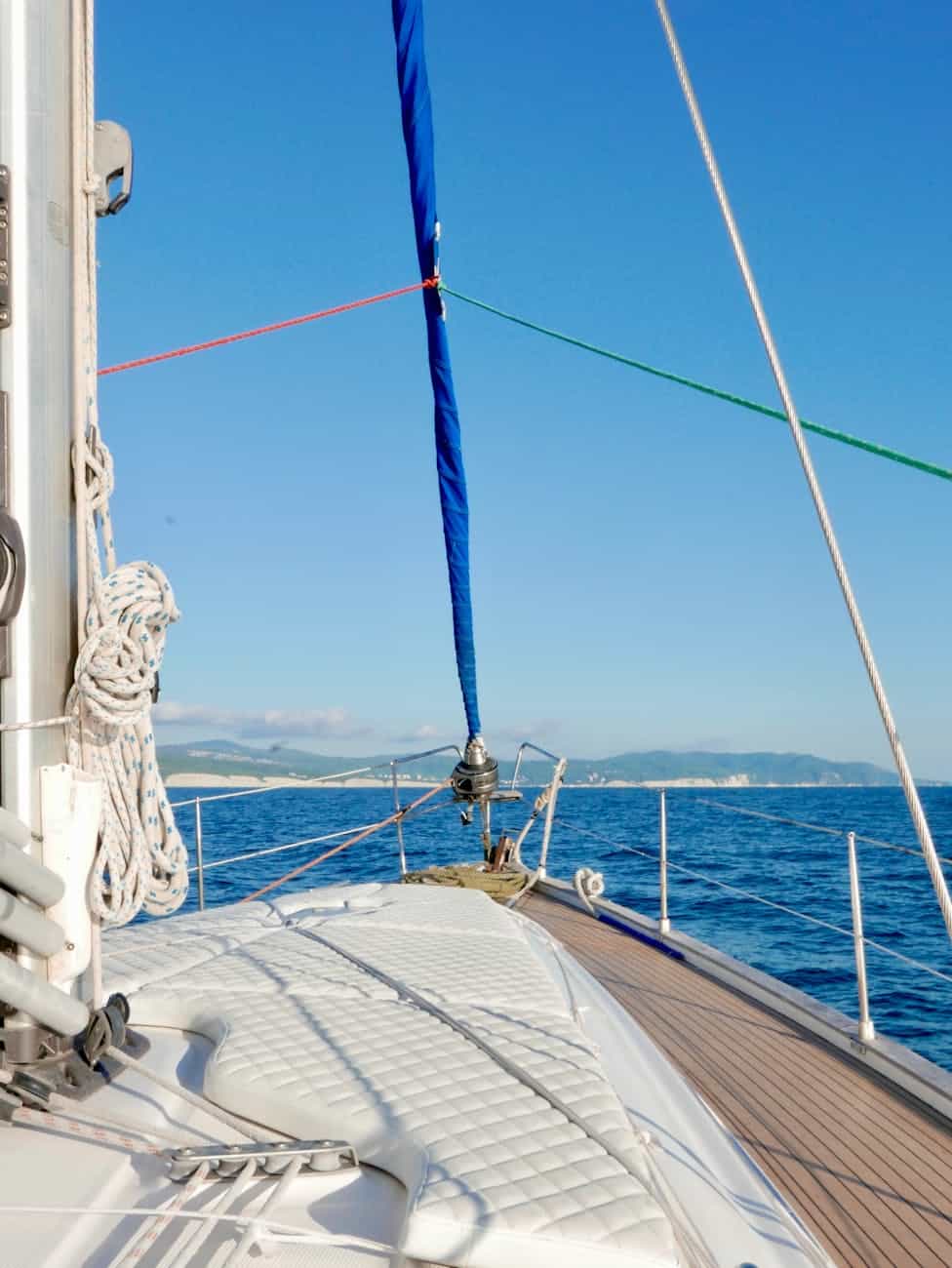Sailing yacht with teak wrap around decks. With a non skid paint bow deck. 