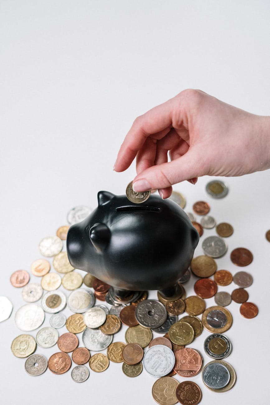Yacht Maintenance Costs person putting coin in a piggy bank to illustrate how yacht maintenance costs and budgeting.