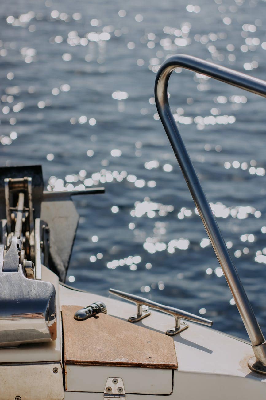 Boat stainless steel cleat on the bow of small yacht. 