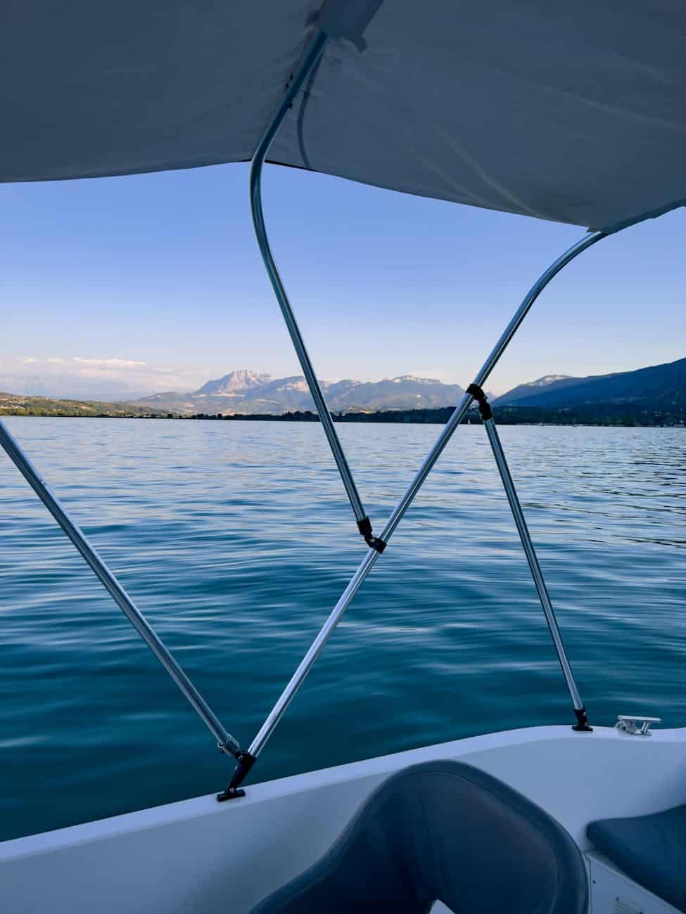 Boat stainless steel on a yachts canopy with a mountain range in the background. 