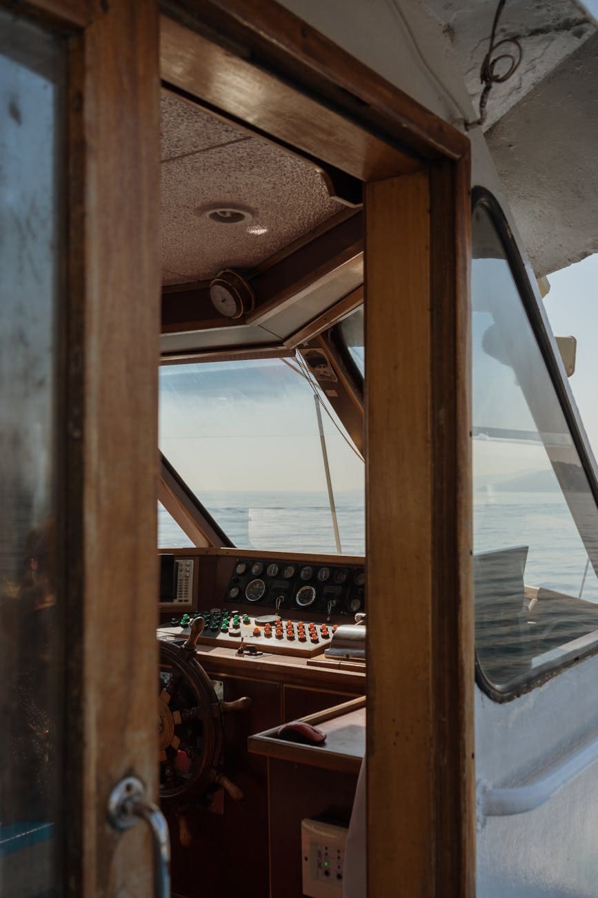 console of a yacht below boat windows looking out onto the ocean. 