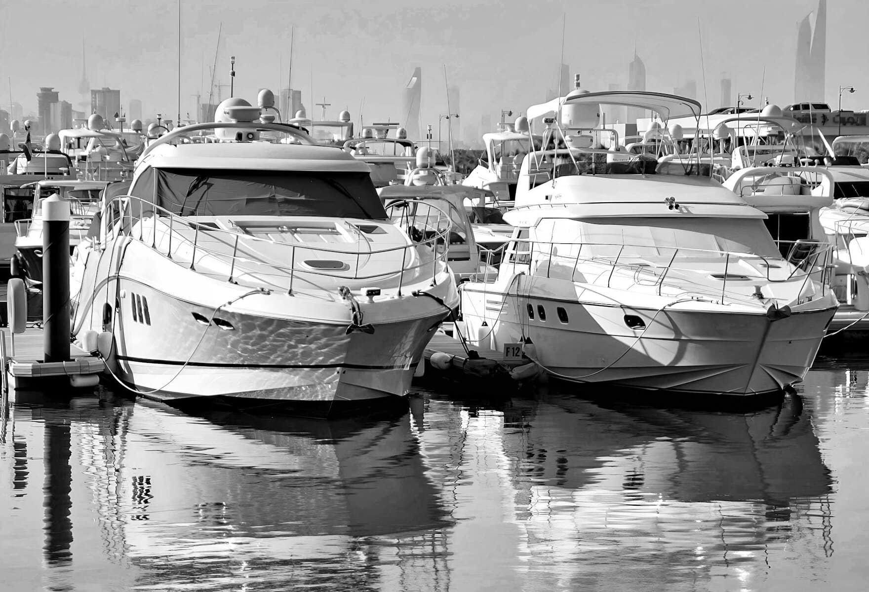 Yachts in an marina in black and white. 