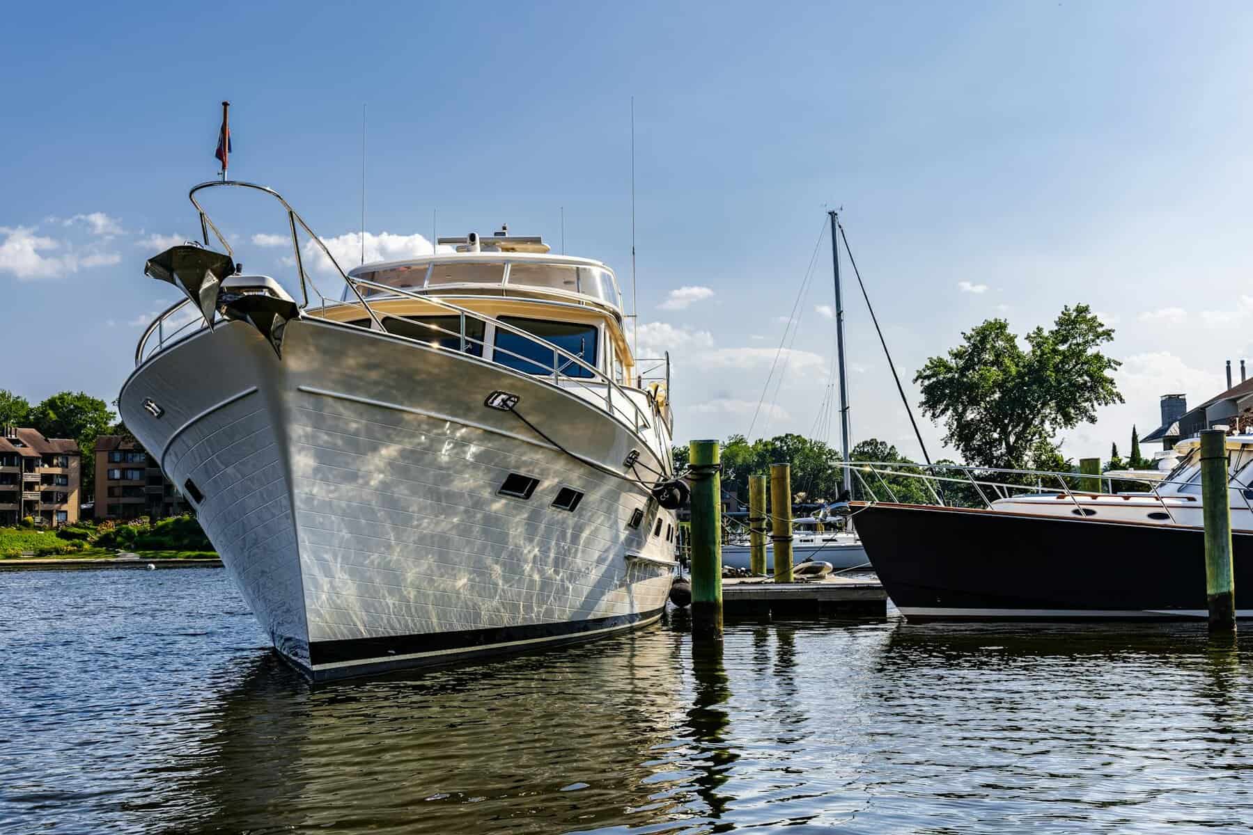 Glossy white and blue boat paint on yacht docked in a marina. 