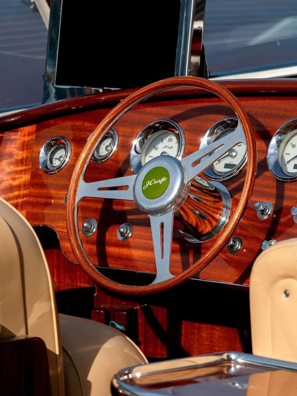 Wooden and metal steering wheel coated in boat varnish. 