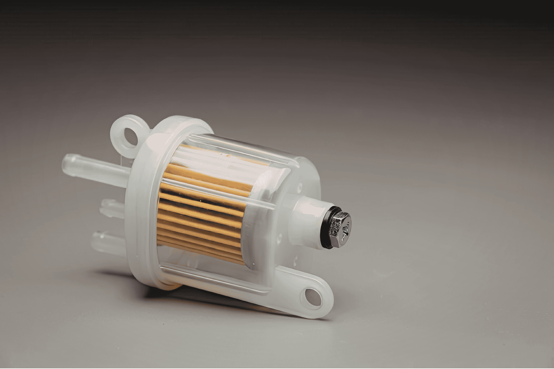Small white boat fuel filter on a grey background. 