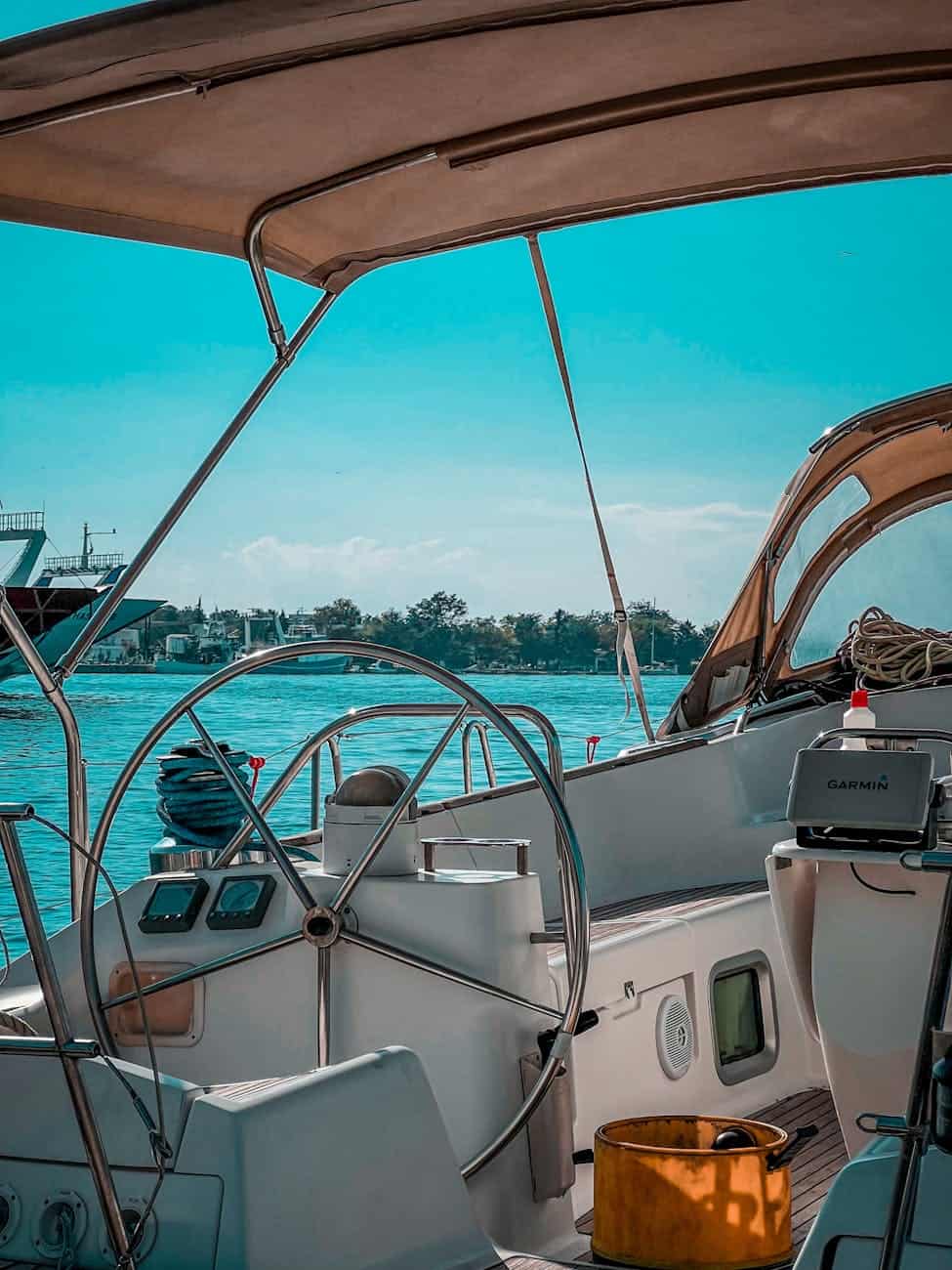 sailing yacht at in port with large steering wheel. 