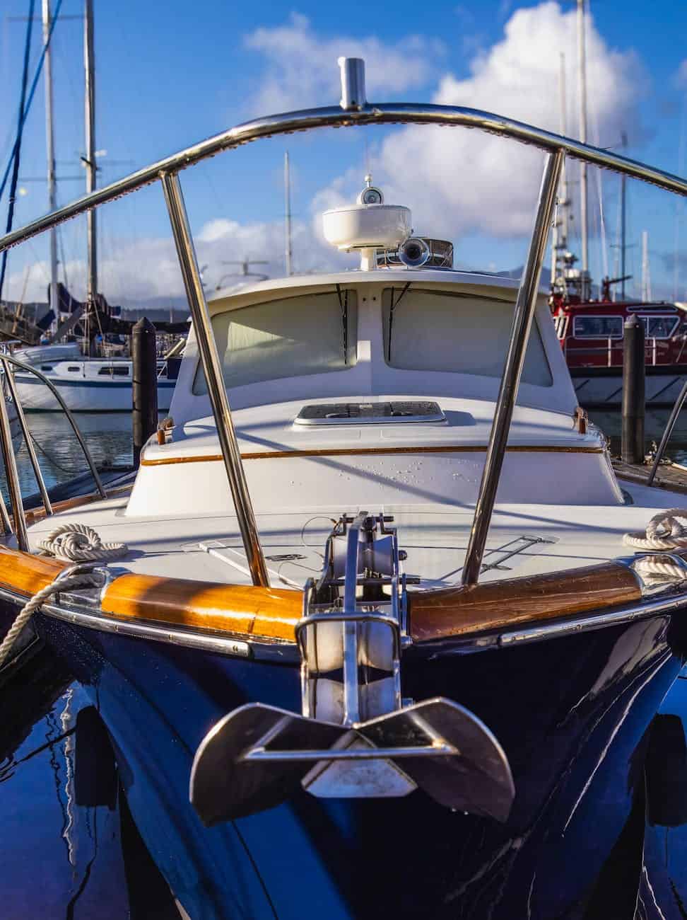 Cleaned and polished yacht with a rub rail of varnished wood.