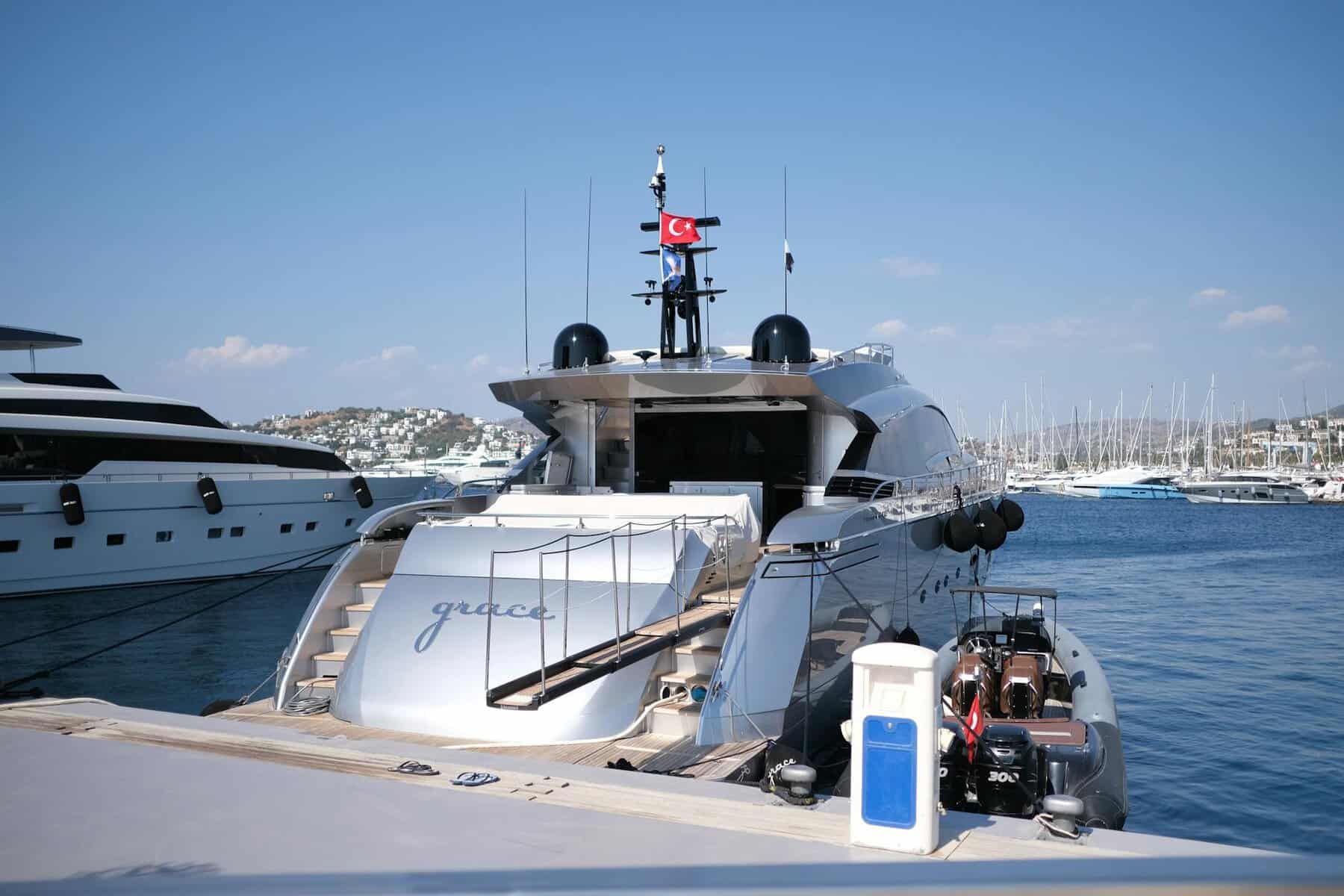 luxury yacht docked with turkish flag in view