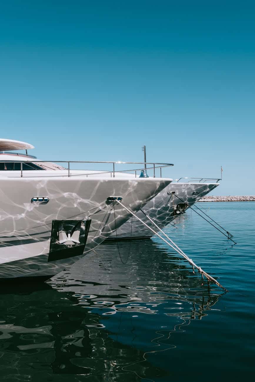 luxury yachts docked at marbella marina with glossy white hulls. 