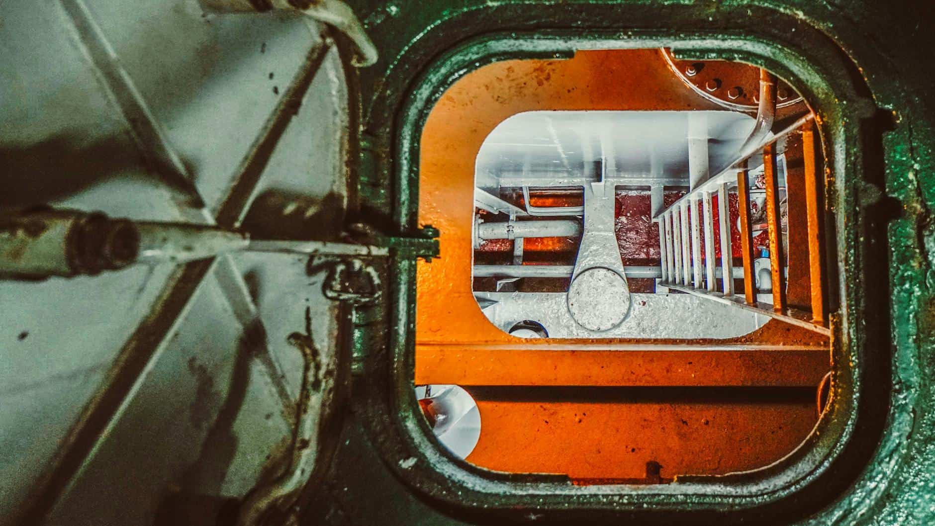 top view of metal ladder entering a boat bilge. 