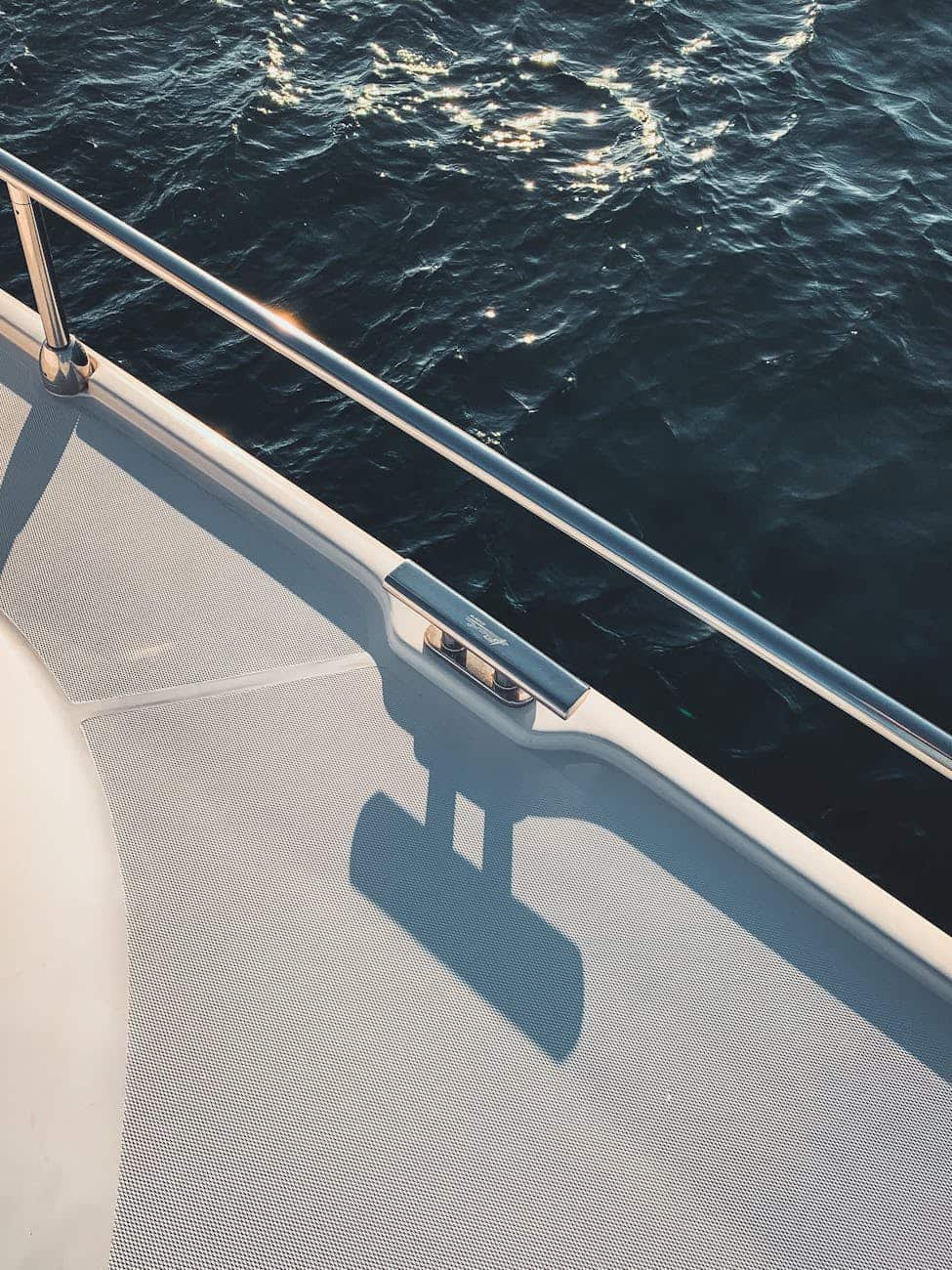 White GRP non skid yacht deck with stainless cleat and handrail.  