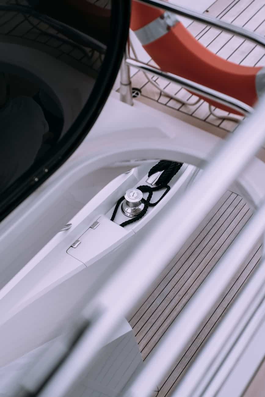 high angle view of a boat gelcoat and teak. With a shinny capstan. 