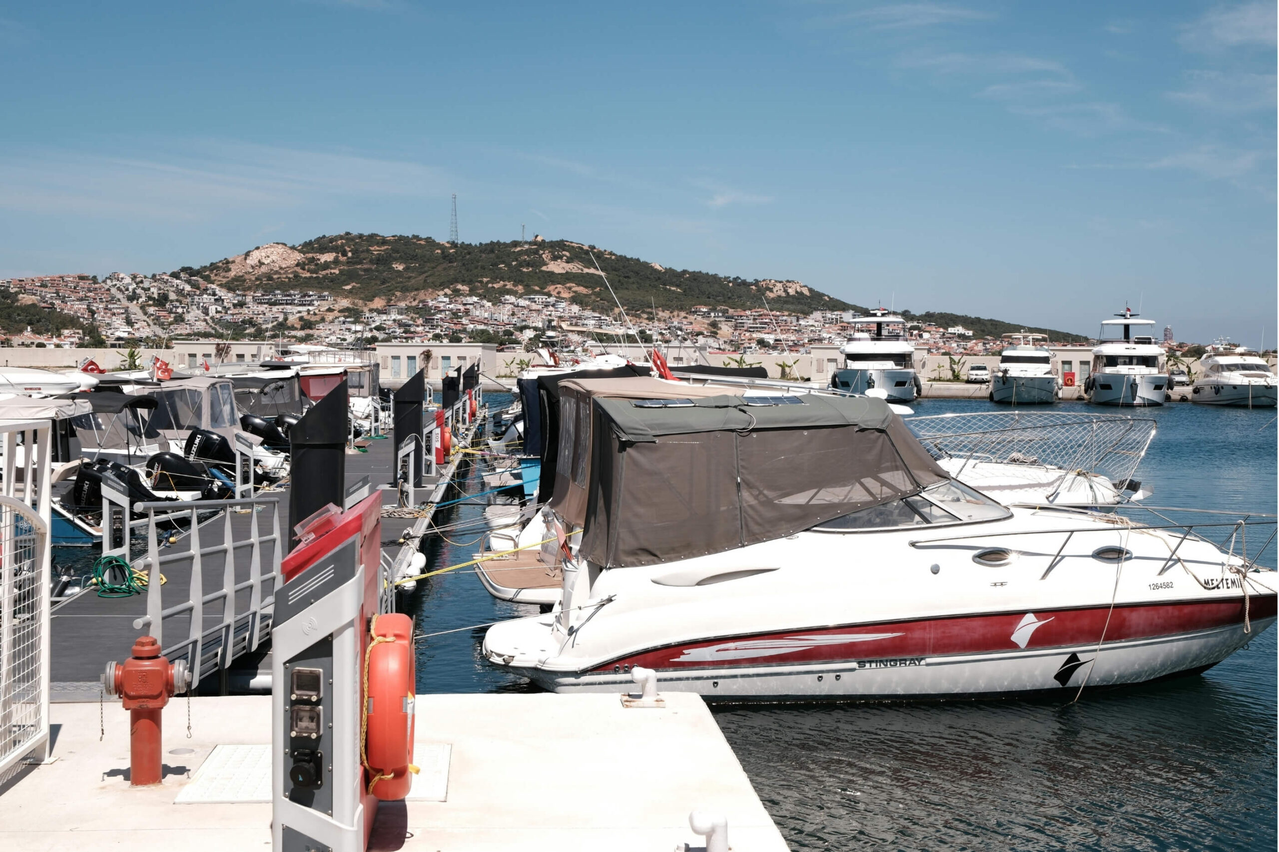 Speed boats docked up next to each other in a marina. 