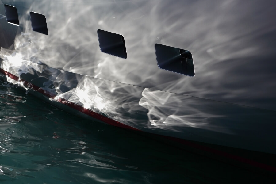 White yacht hull glistening in the water. 