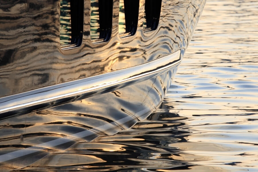 Dary navy blue hull of a yacht that has ceramic coating on it. 