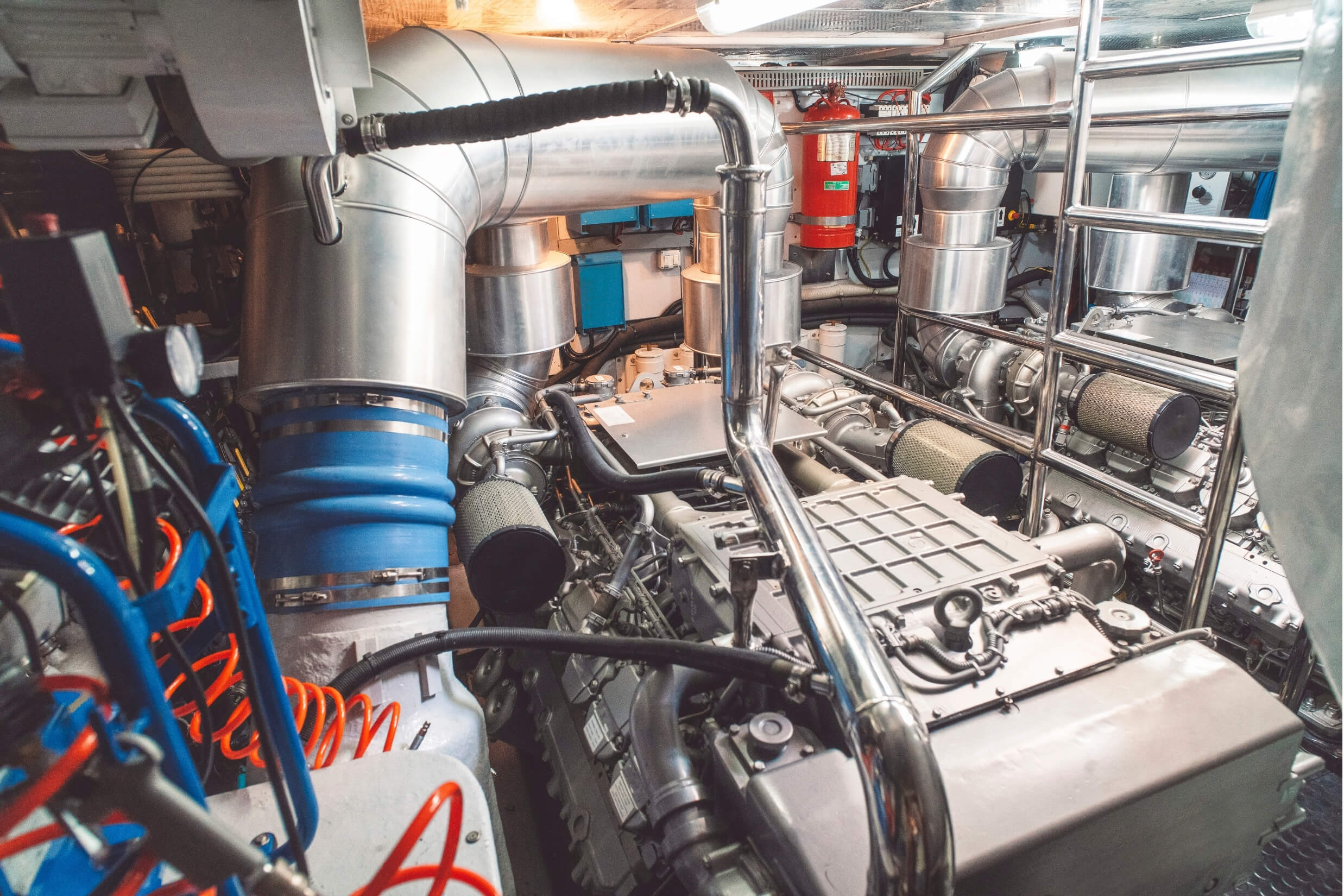 Engine room of a boat with 2 large engines inside. 
