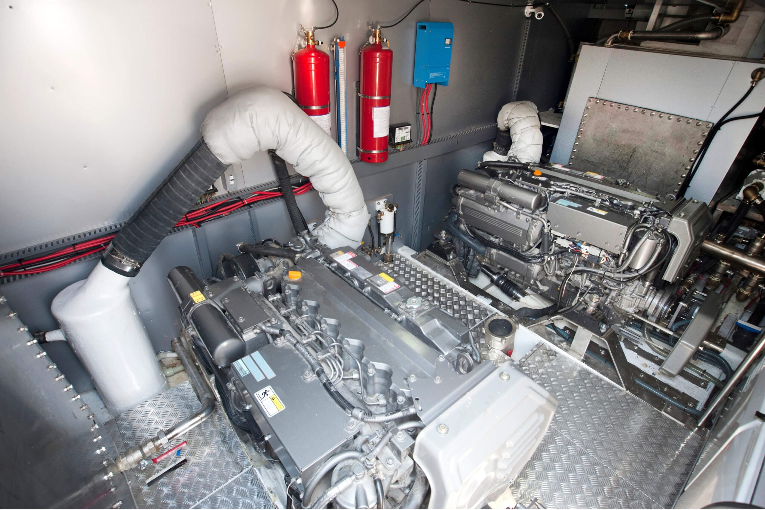 Marine engine room with 2 large engines inside. 