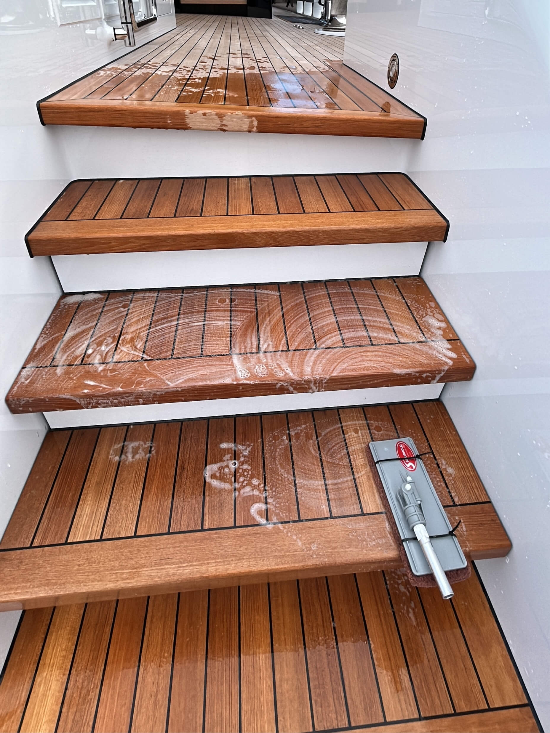 Teak staircase being scrubbed clean.