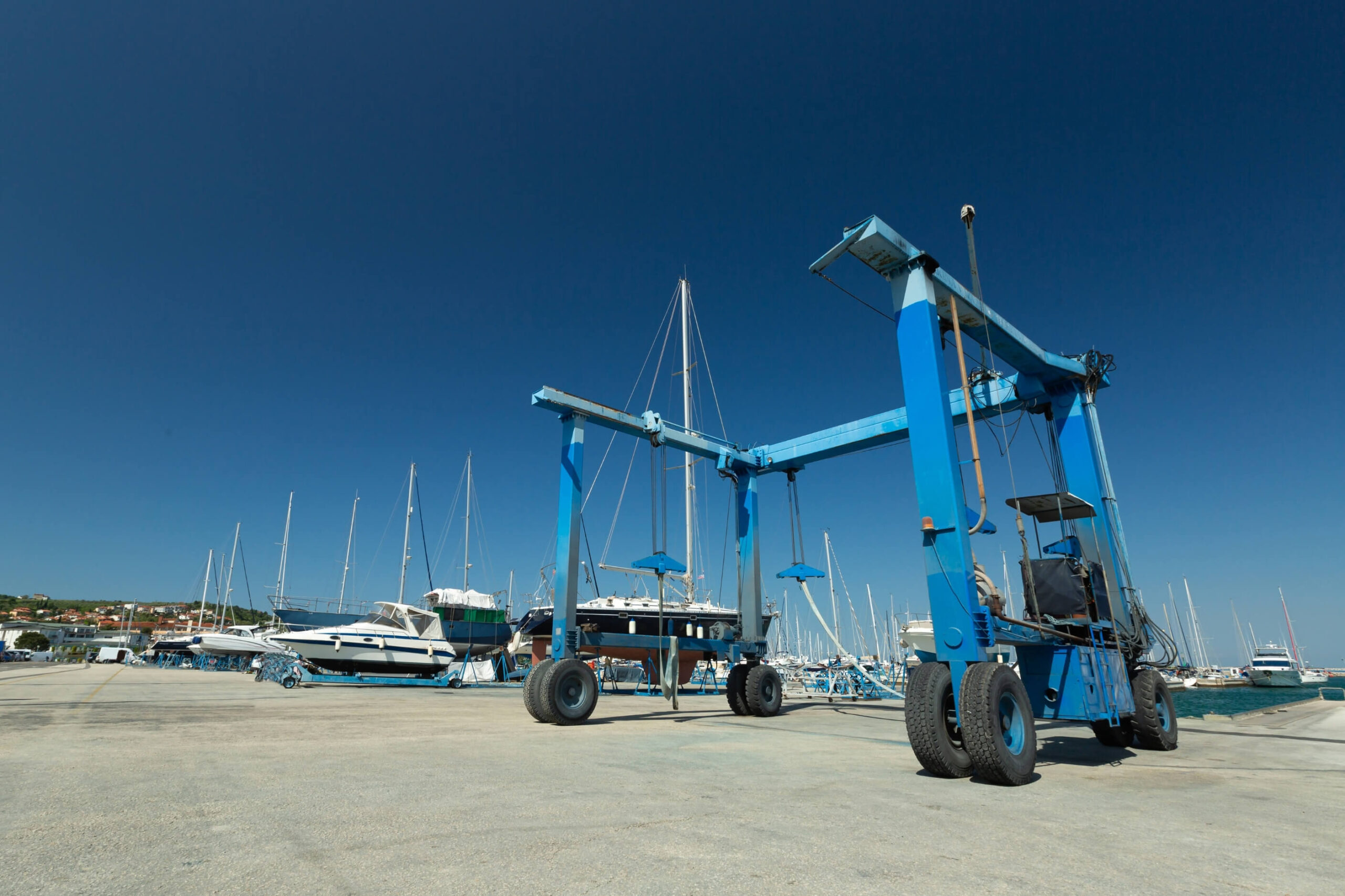 blue boat haul out lift in a marina yard.