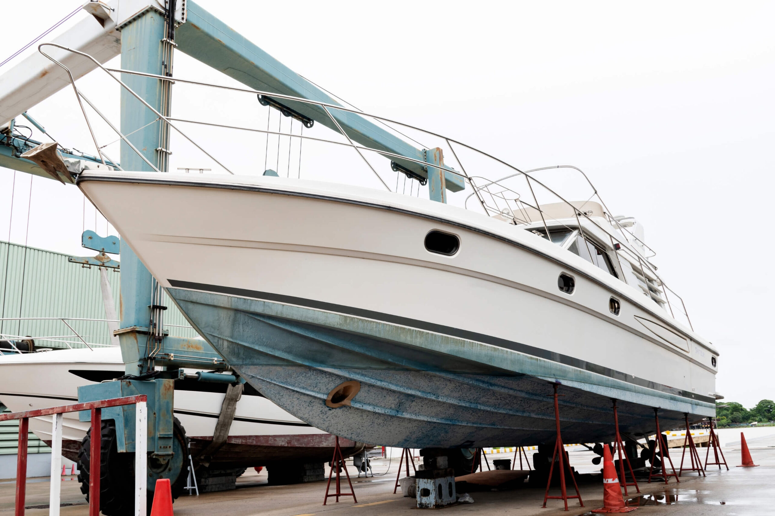 Motor yacht out of the water propped up on chocks. 