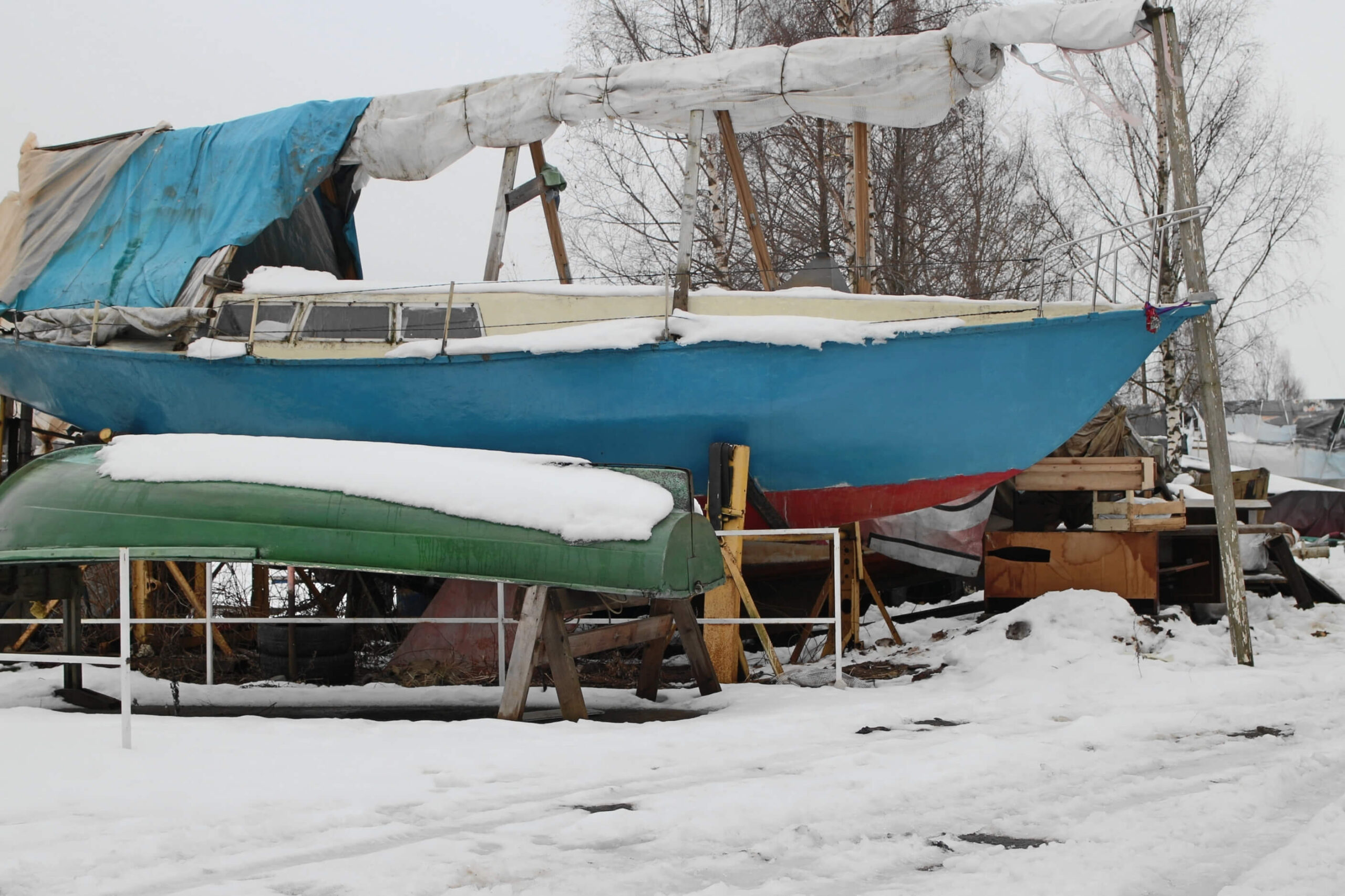 Boat in winter storage covered in snow. 
