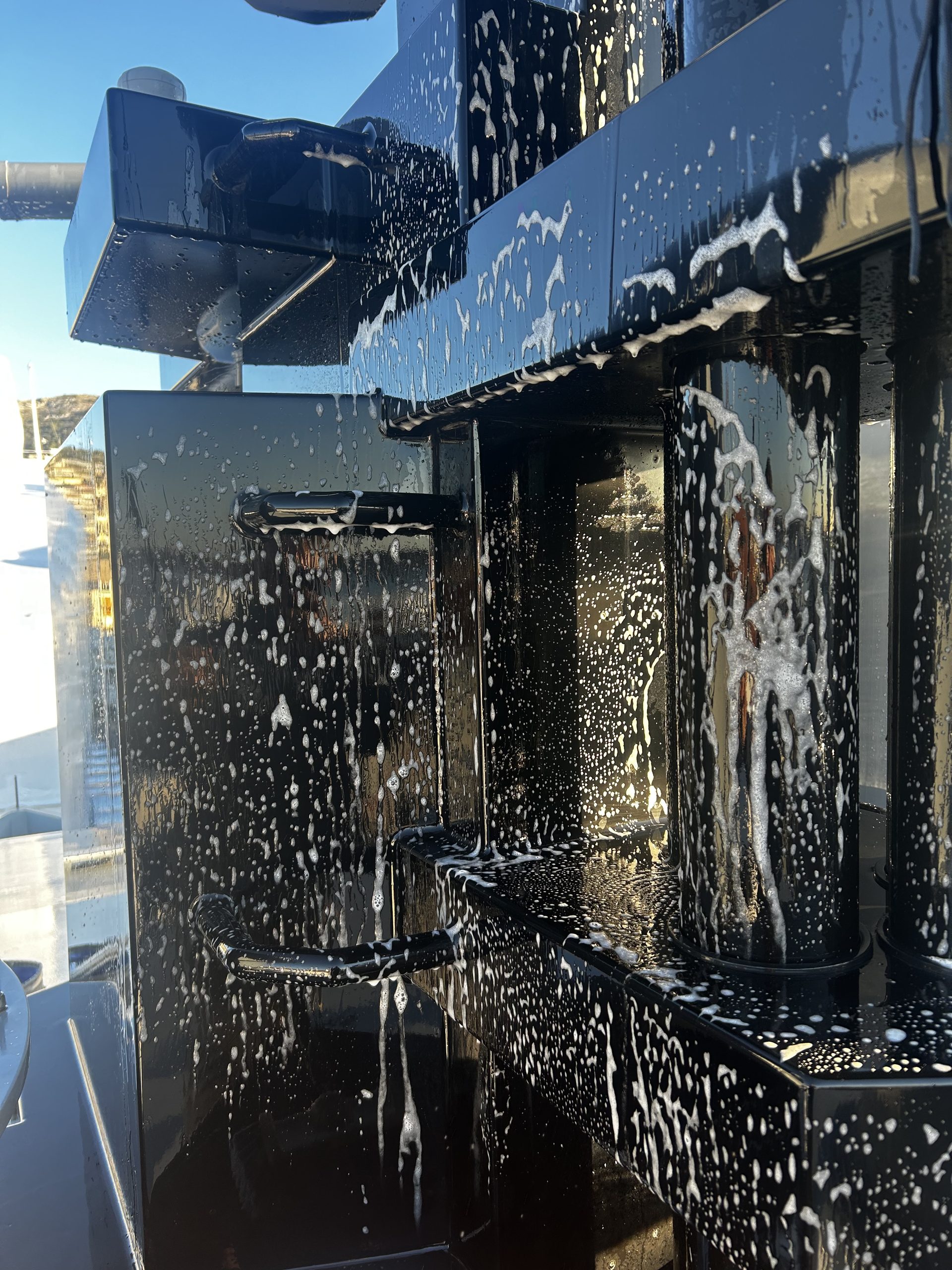 Boat soap on a black mast of a superyacht. 