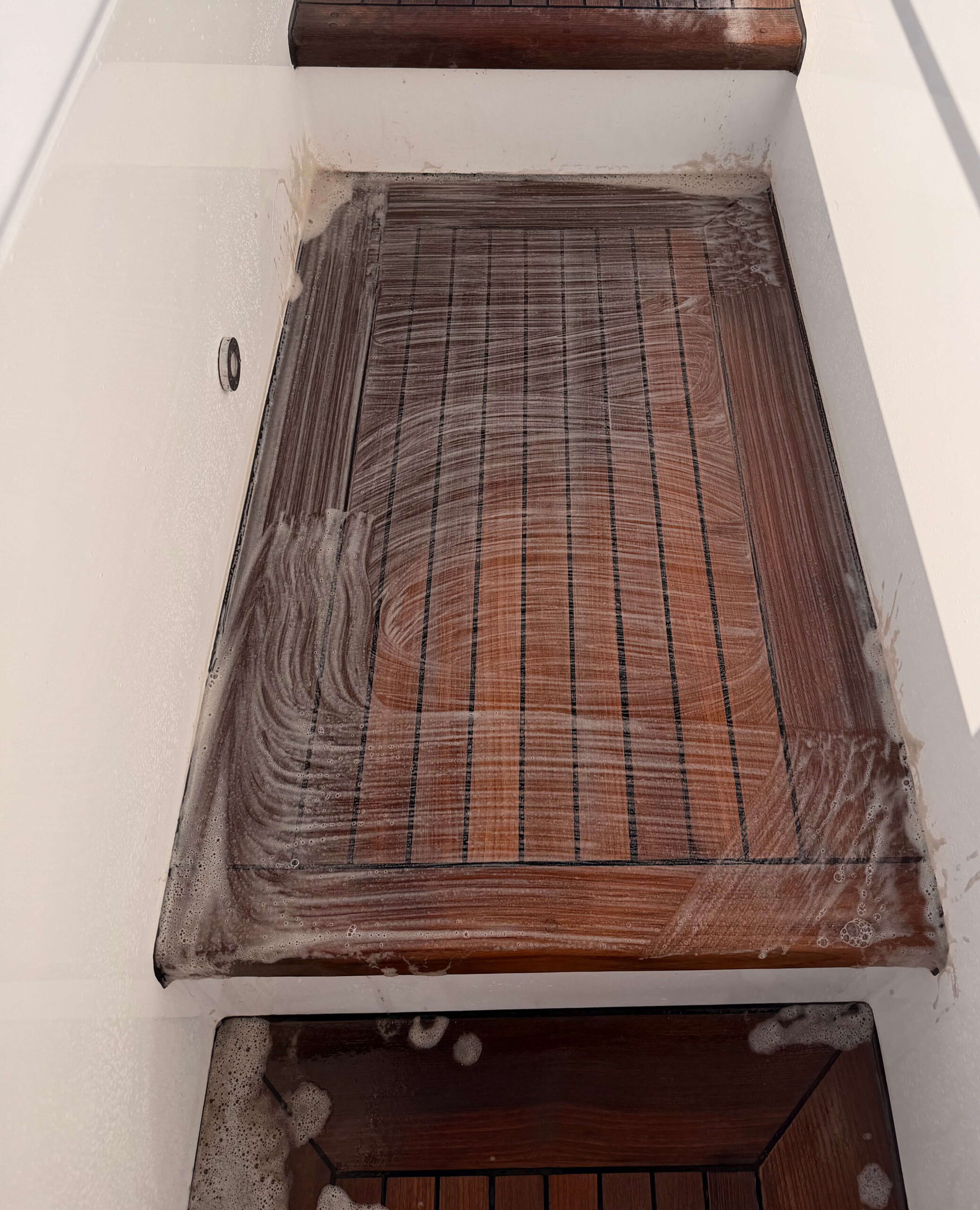 Teak decking step being cleaned and restored. 