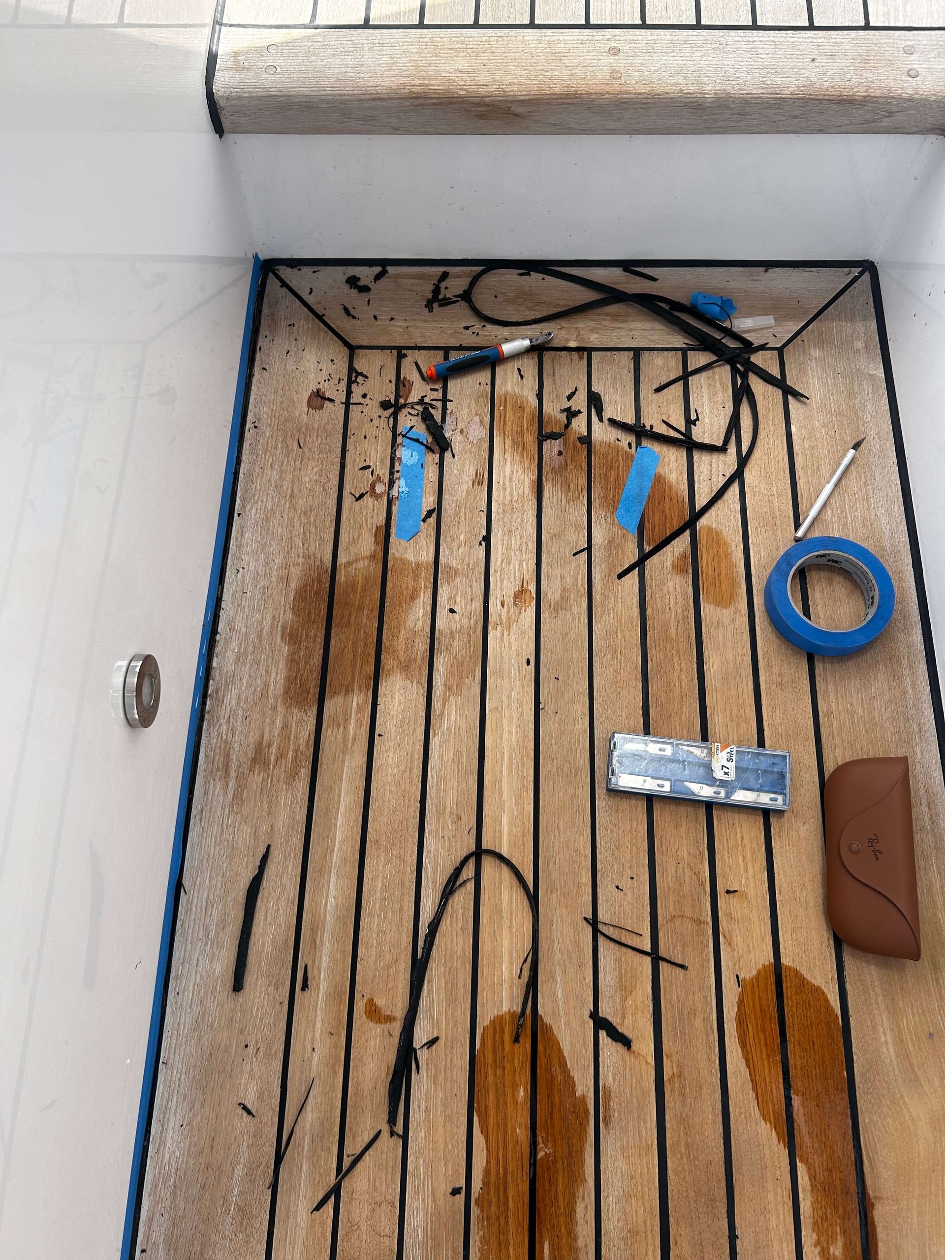 Teak caulking being removed and restored. 