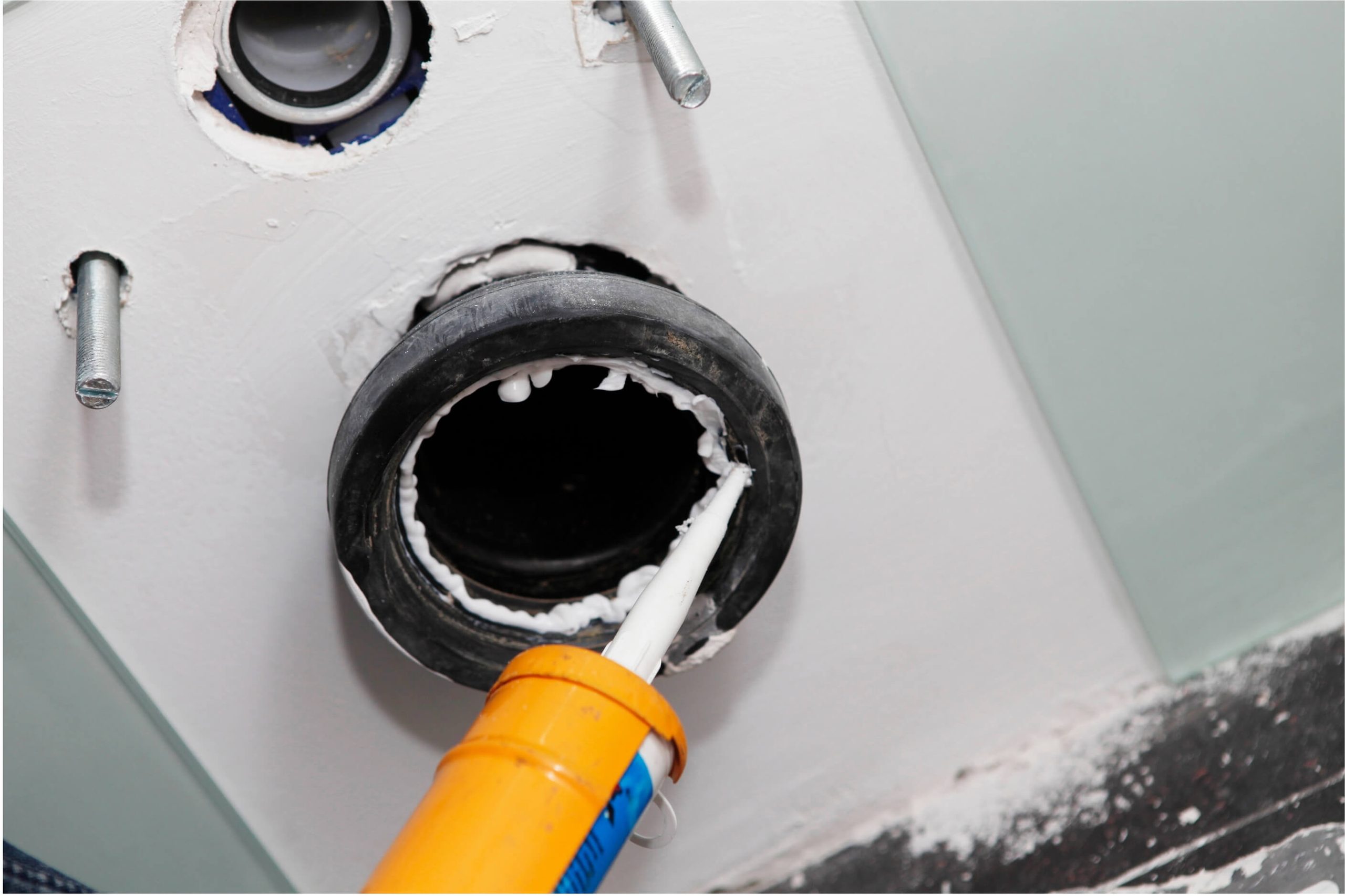 Marine sealant being applied to a fitting. 