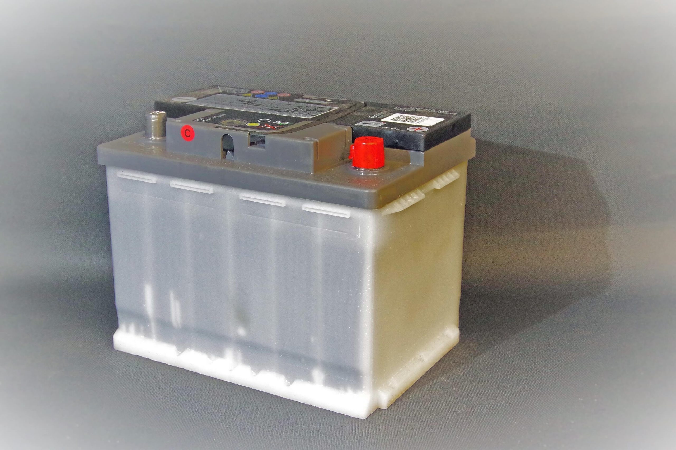 Battery cell on a grey background. 